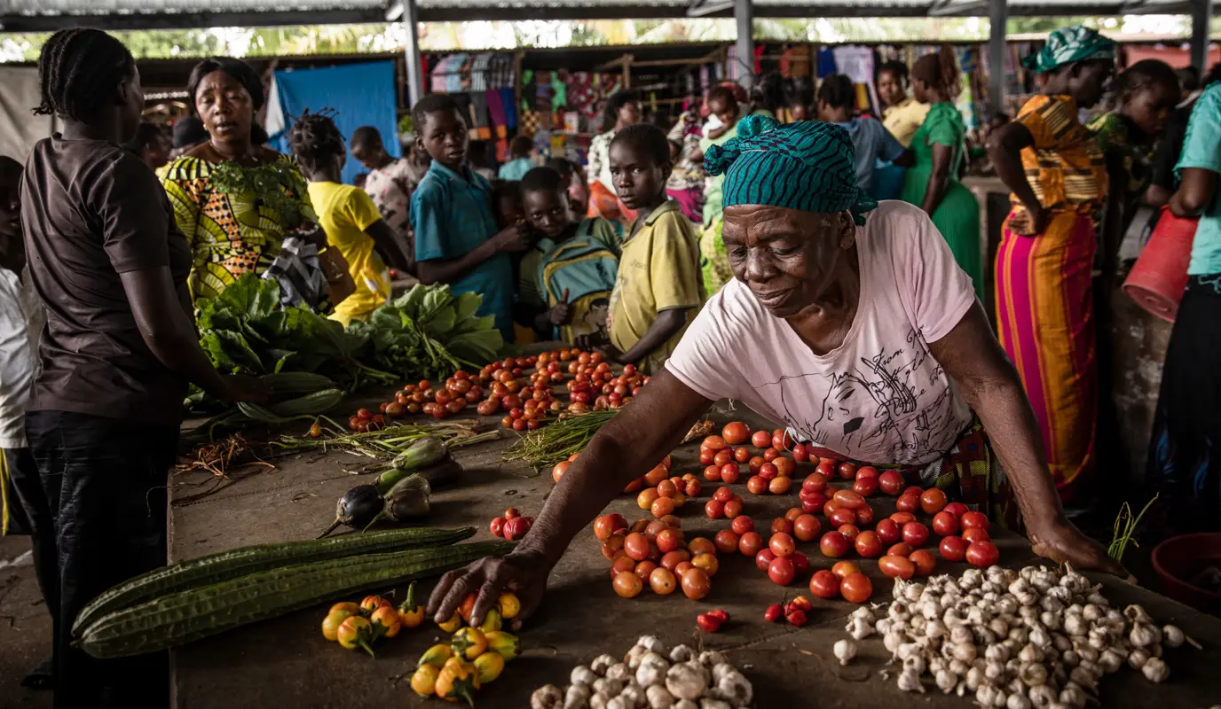 Francoise Kakuji lays out her vegetables for sale at the central market of the town of Manono, Tanganyika Province, DRC.