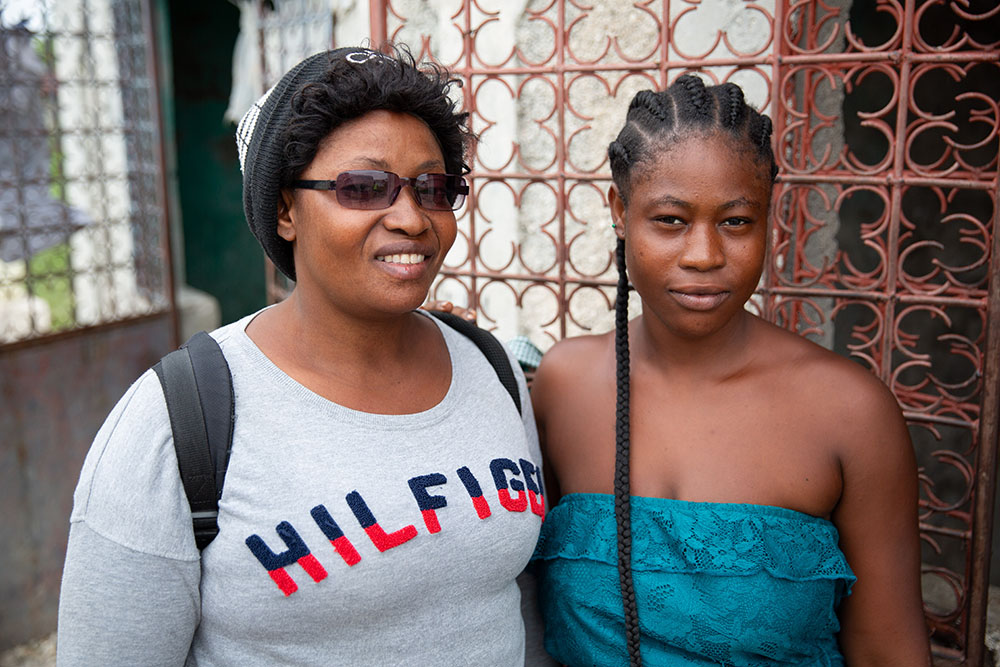 a community worker with one of her clients in Haiti