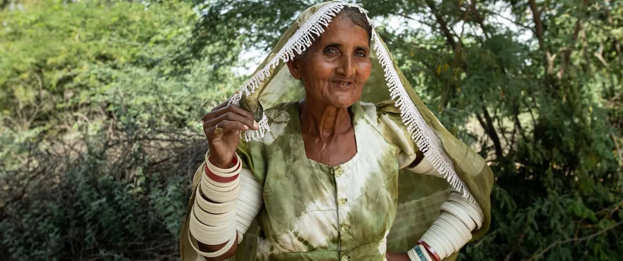 Elderly woman posing with garment over her head