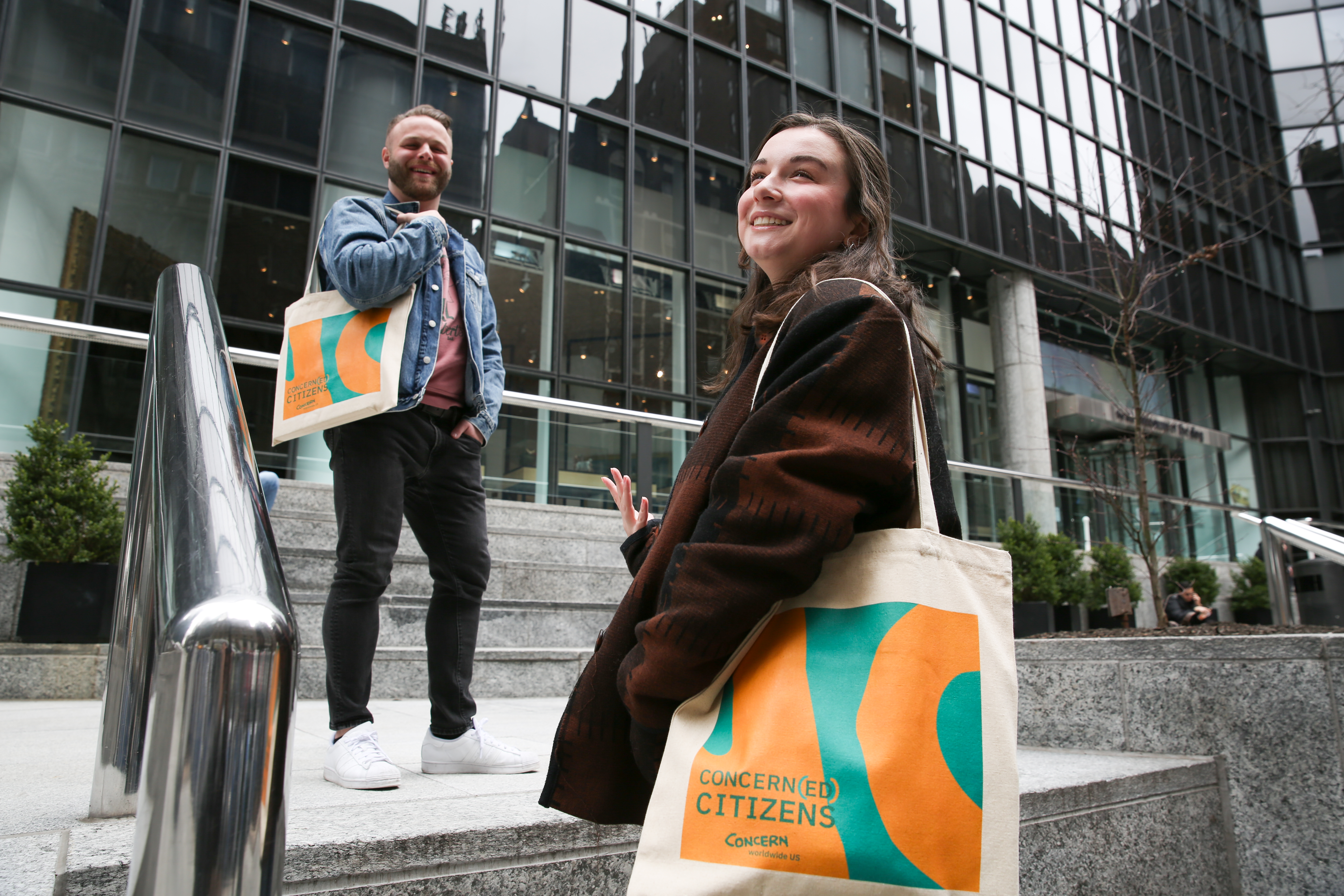 Two people using the Concerned Citizen Tote