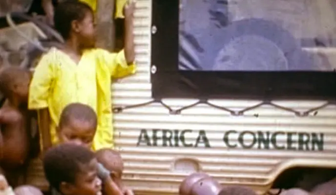 Children stand beside the Africa Concern truck in Biafra, ca. 1968