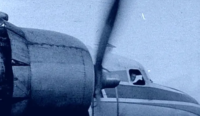 propeller plane with pilot looking out window propeller plane with pilot looking out window