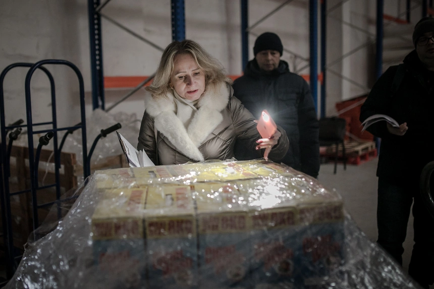 A member of the Joint Emergency Response in Ukraine team inspects a shipment of aid supplies in Khmelnytskyi.