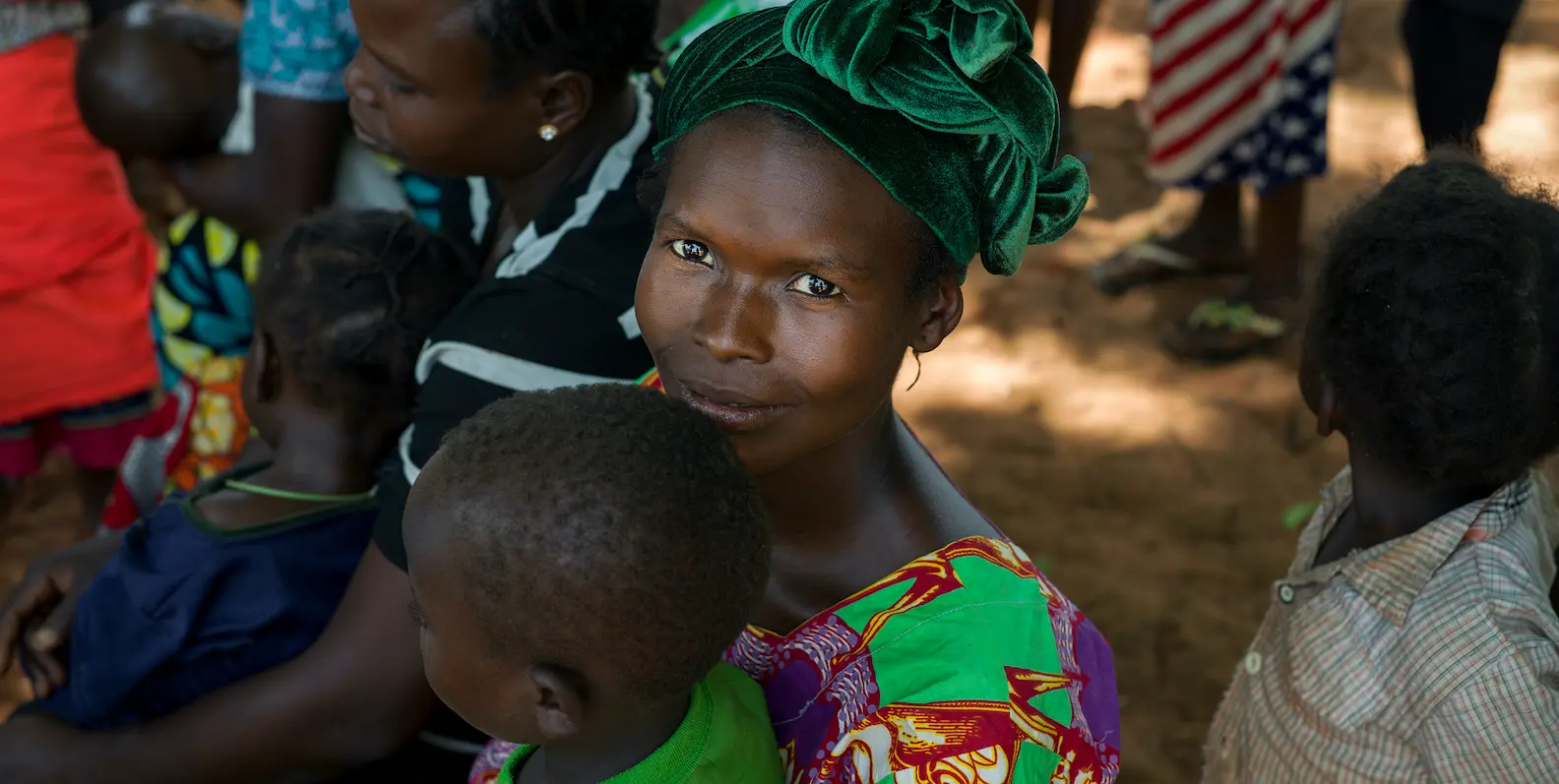 Woman holding a young child at Concern's mobile clinic in the village of Gbwai, CAR.