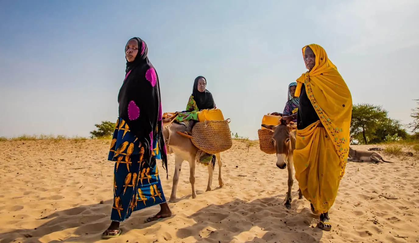 Three women walking to find water