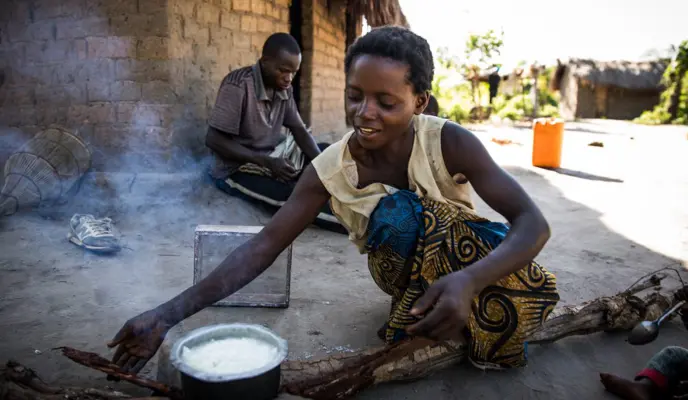 Mado Kabulo, 29, prepares breakfast to share with her husband Eric and their children in the village of Pension, Manono Territory, DRC.