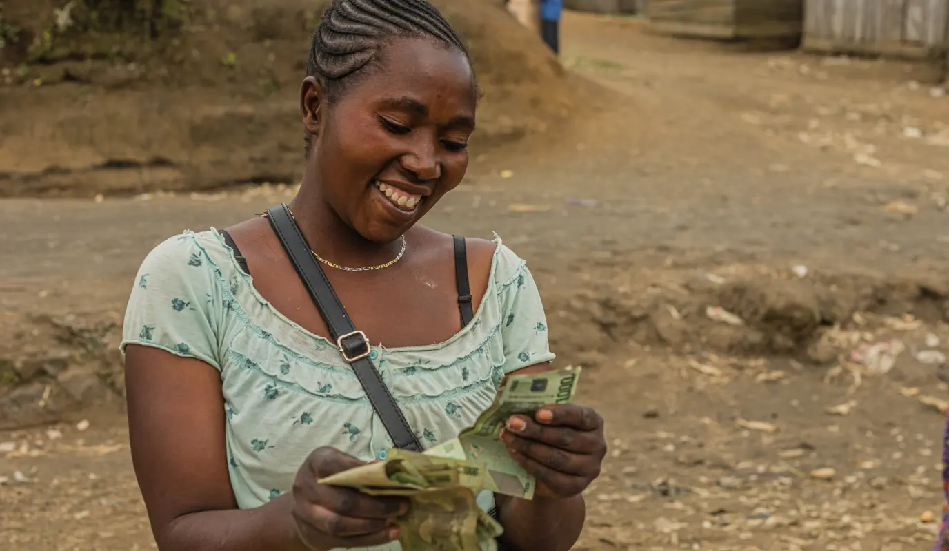 Local woman counting her money after a day of selling items at the local market.