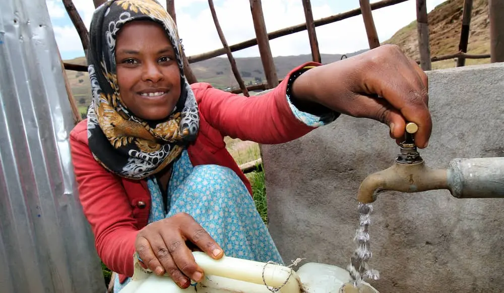 Dereba Kebele collects water from a water source built in Ethiopia.