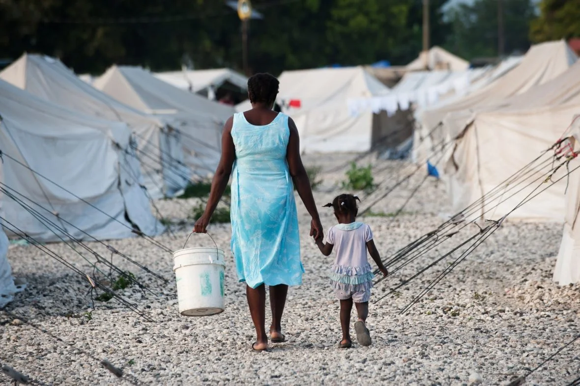 A mother and her child on Tabarre Issa settlement, October 2010.