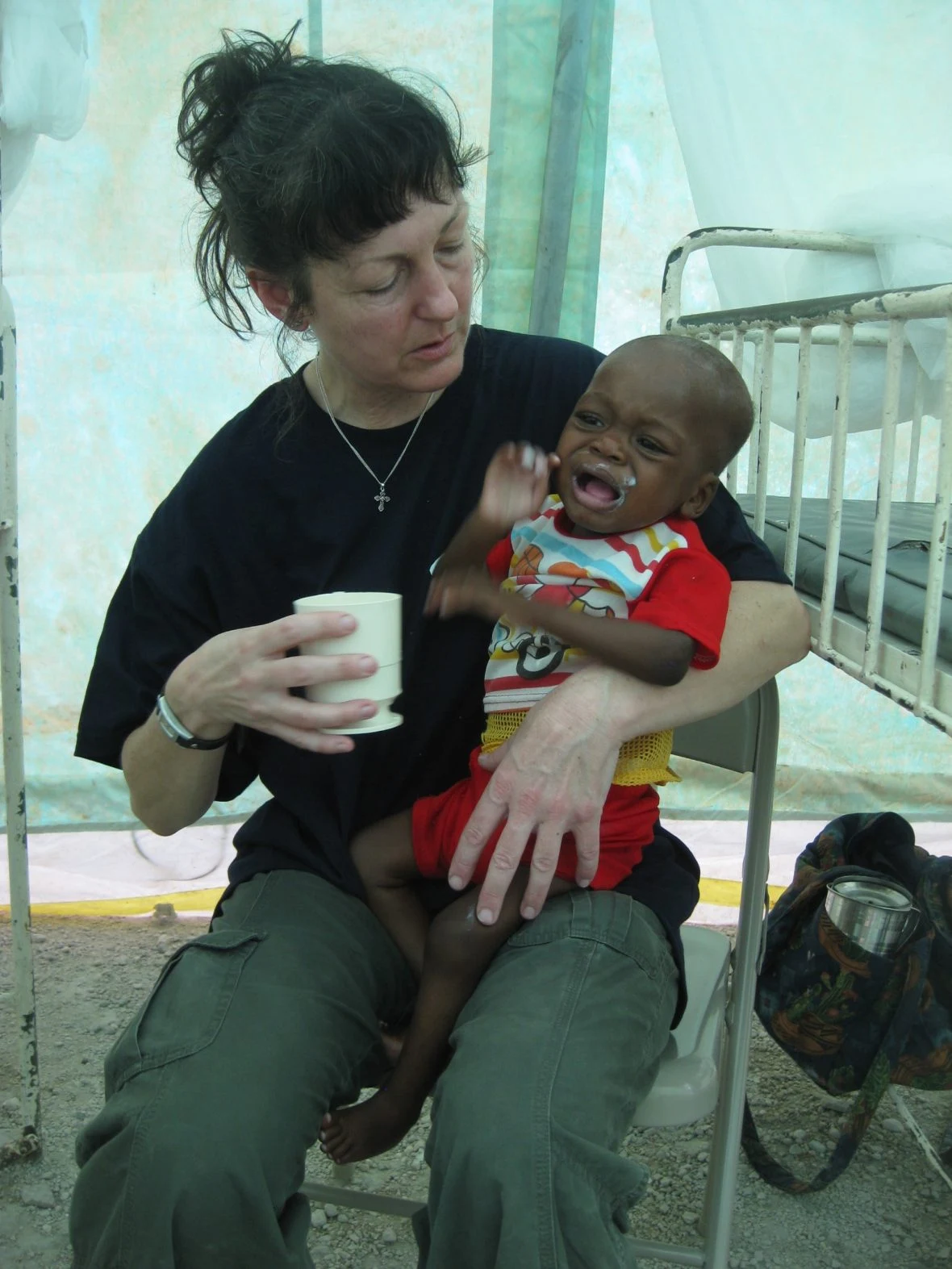 Emergency nutritionist Bernadette Feeney treats Johnsley Pierre at National University Hospital, Port au Prince, January, 2010.