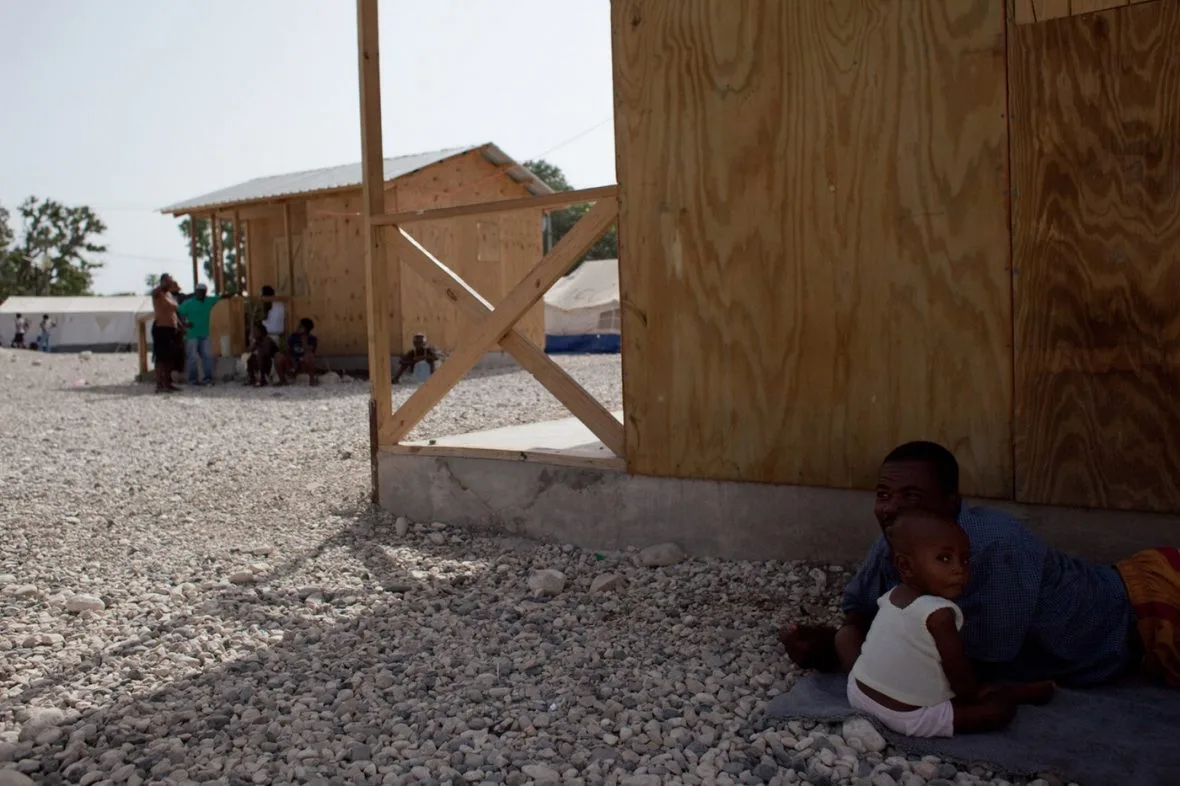 Children in the shade of a shelter.