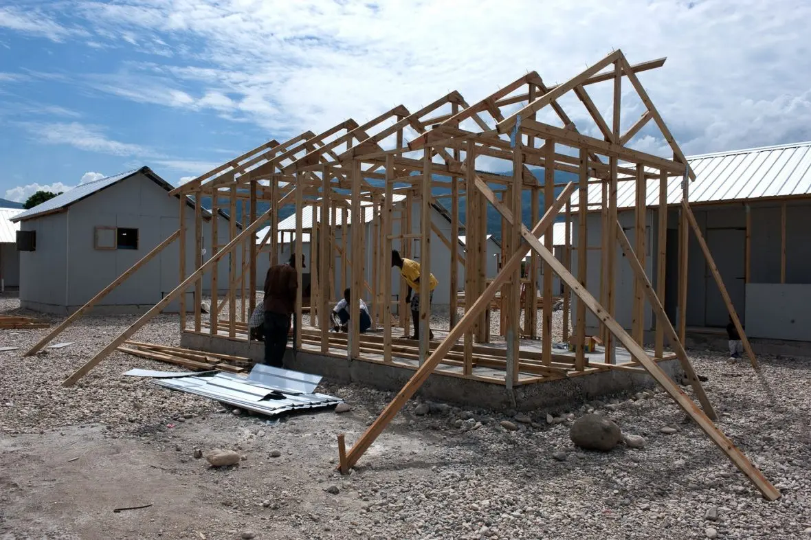 3 people building a house.