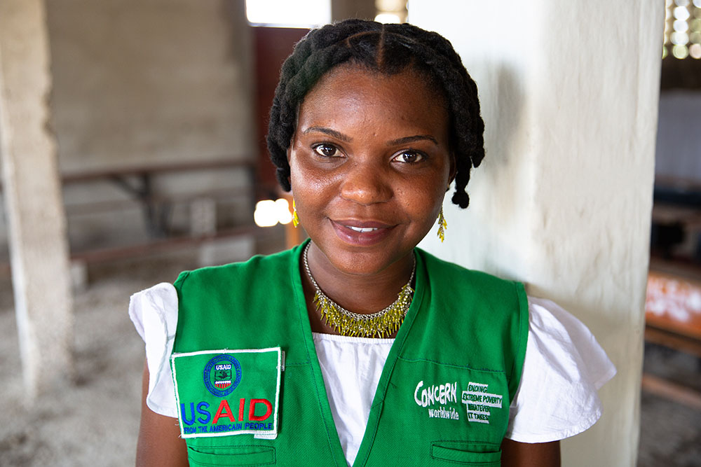 Concern worker sitting with a woman and her baby