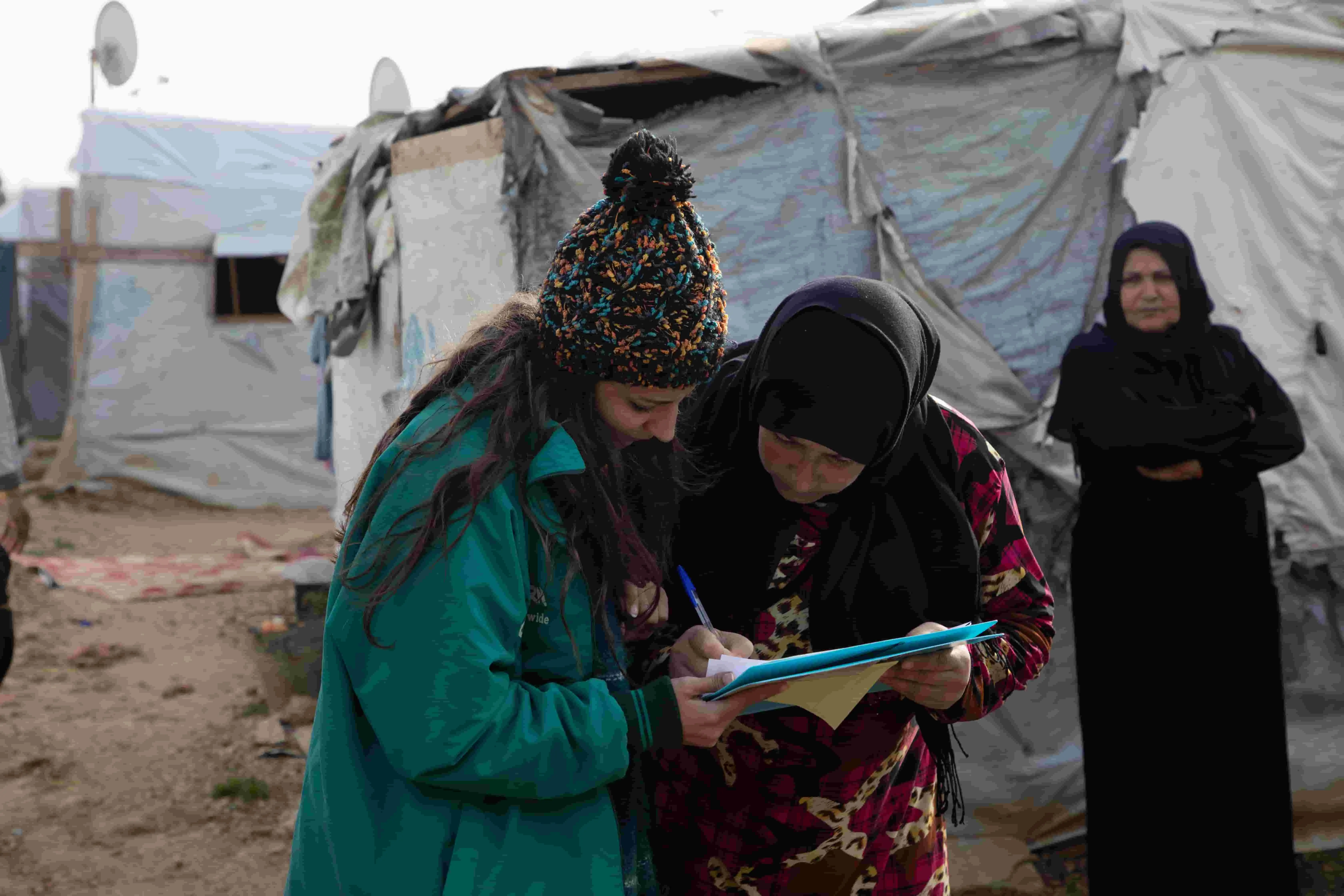 Women view a document on a clipboard