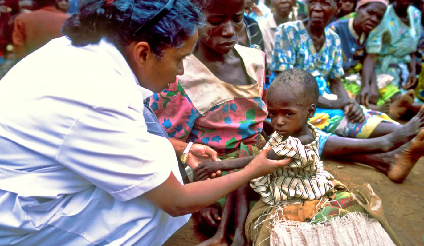 Nurse Sr Walsama checks a malnourished child in the Dowa region of Malawi in 2002 as part of Concern and Valid's CMAM program. (Photo: Pieternella Pieterse)