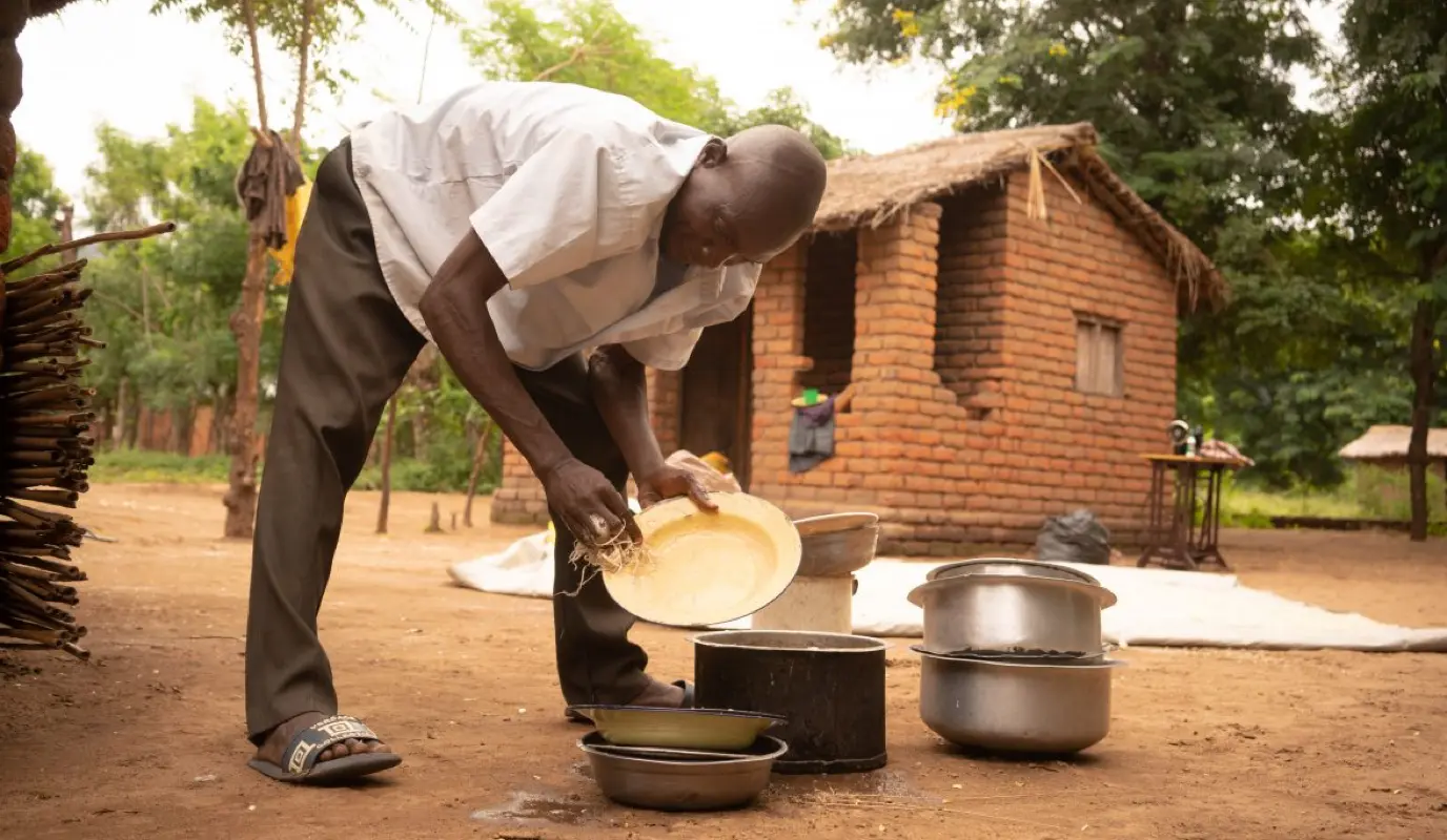 Forty Sakha helps his wife with the dishes and other household chores in Nsanje, Malawi. Forty Sakha helps his wife with the dishes and other household chores in Nsanje, Malawi.