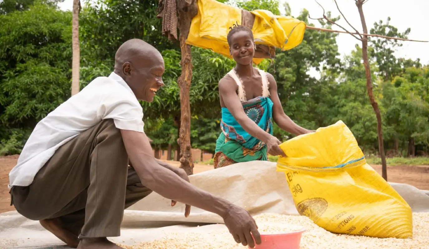 Since partaking in the Umodzi gender program, Forty Sakha helps his wife Chrissy with household chores like drying maize. Since partaking in the Umodzi gender program, Forty Sakha helps his wife Chrissy with household chores like drying maize.