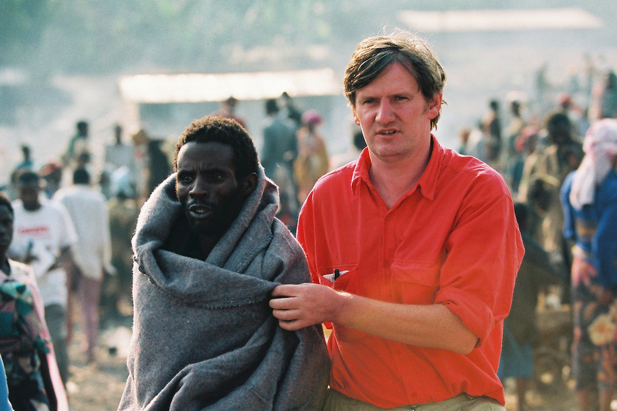 Concern Volunteer Noel Molony brings a displaced Rwandan man to a clinic to be treated for cholera. (Photo: Liam Burke/Press 22/Concern Worldwide)