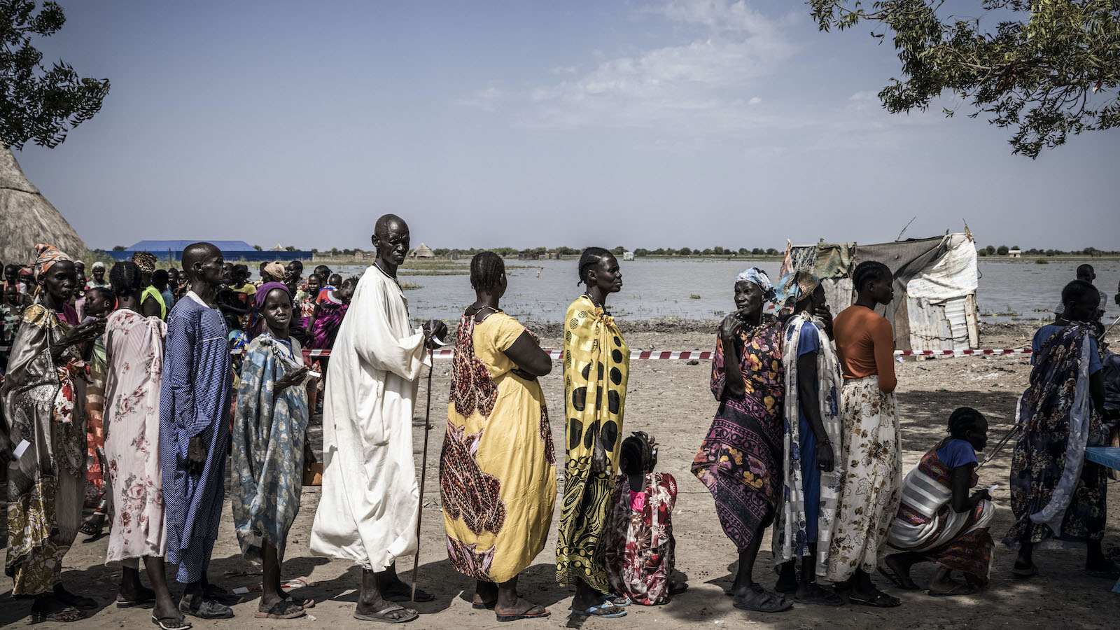 Nyepahan Ketket (in blue and yellow dress) is registered and given money in a cash distribution in Chotyiel, a settlement surrounded by flood water near Gwit in South Sudan's Unity State. (Photo: Ed Ram/Concern Worldwide)