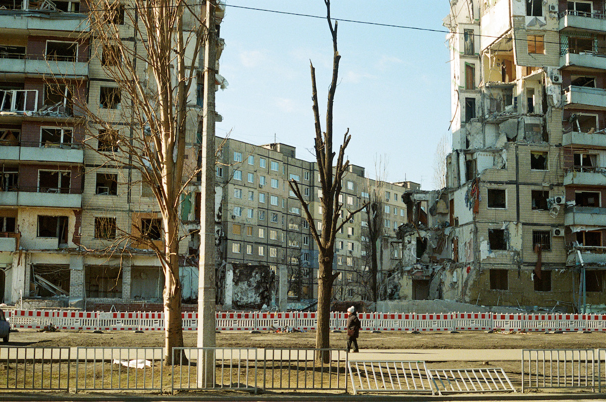 A woman walks by the remains of an apartment building in Dnipro, Ukraine. The complex was destroyed in a shelling in January, 2023.