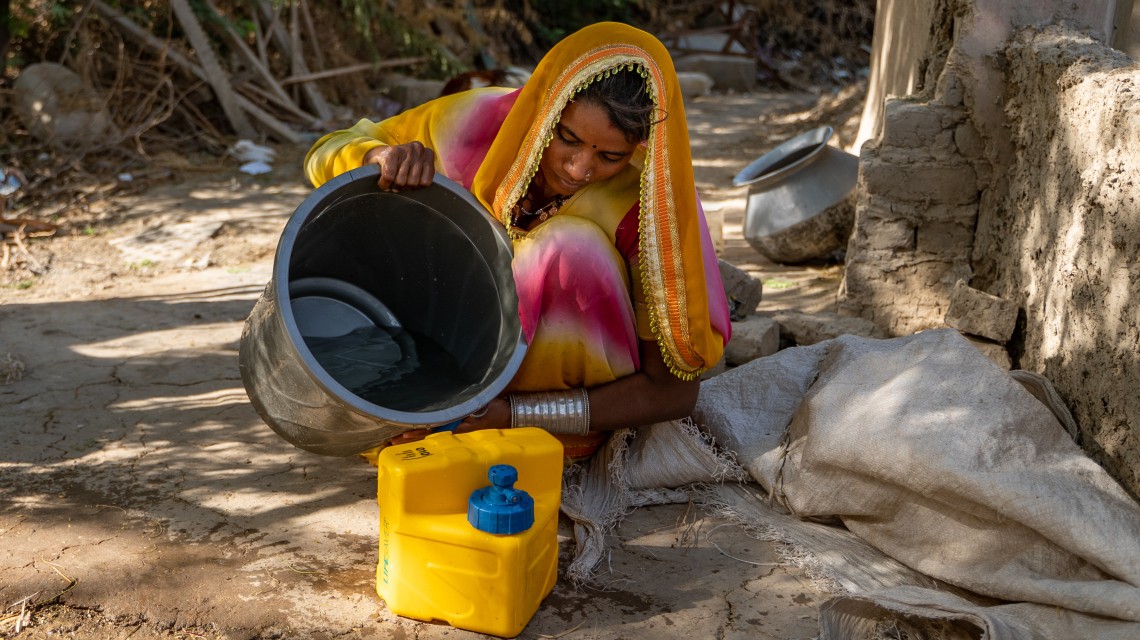 Neelam (22) filters water in Village Haji Muhammad in Pakistan's Umerkot district.