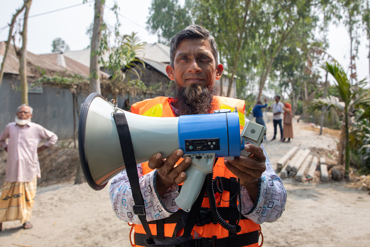 Ashraf is the president of the committee alert group. The group alert people to bring livestock in when the cyclone comes. Once they get the word it is coming, committee members go out with loudspeakers and life jackets to alert everyone of the dangers on their way. This equipment was given to them by Concern. They use ‘local tech’ to stop erosion. They make bamboo bridges so that people can move around. Photo: Gavin Douglas/Concern Worldwide