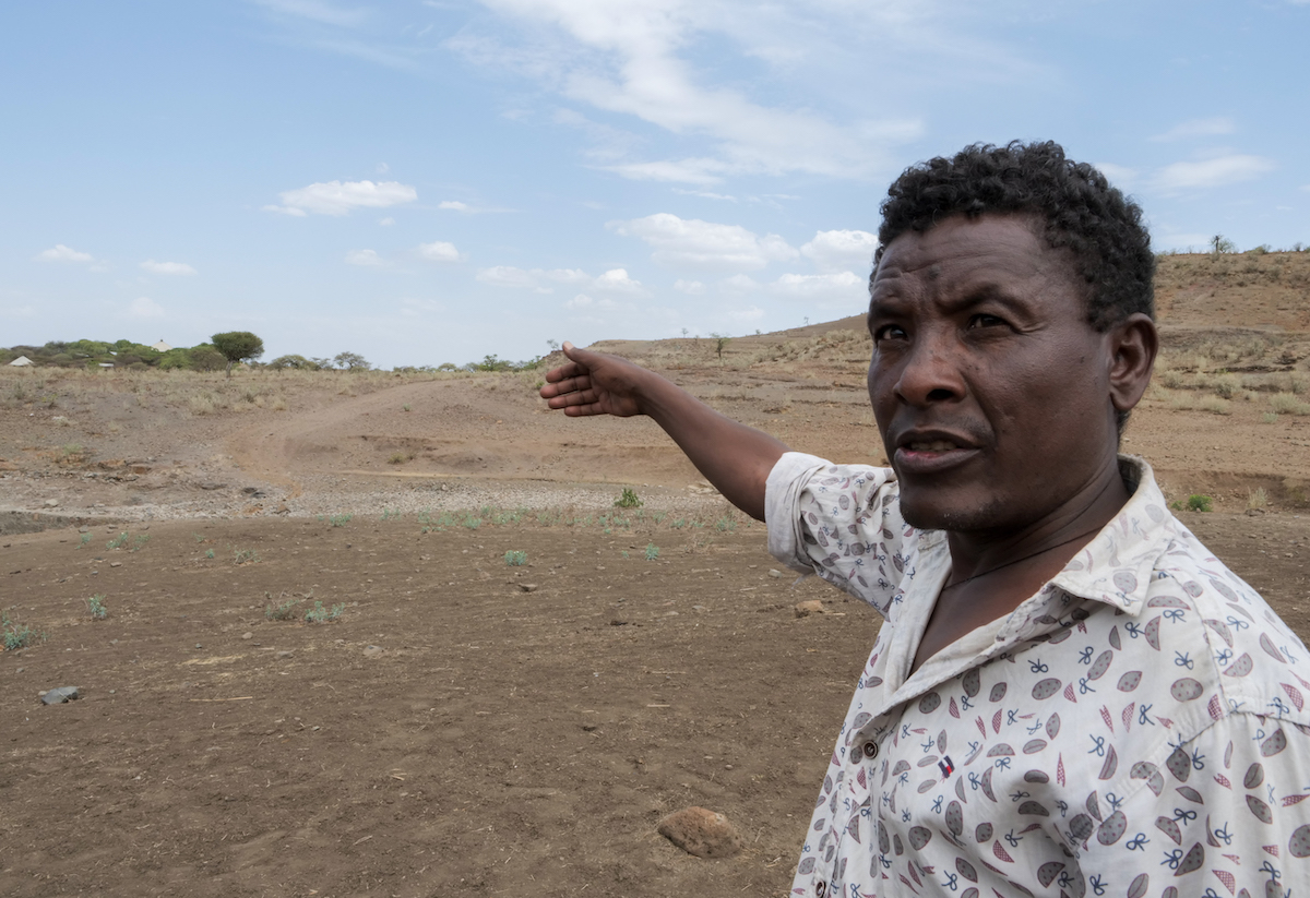 Head of Hamsit Kebele Agriculture office Mulu Chorie showcases the area covered by the Cherkos community watershed, part of the ReGRADE II program in Ethiopia. (Photo: Eugene Ikua/Concern Worldwide)