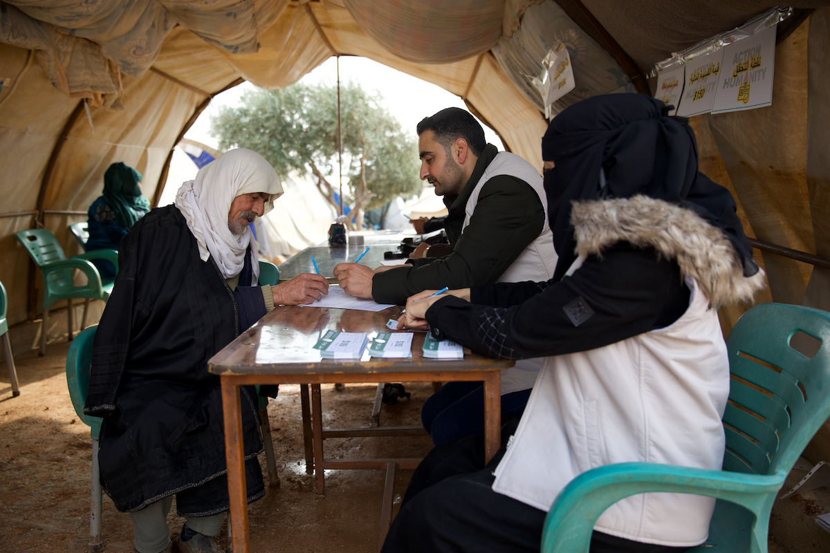 Omar* (66) receives a cash voucher distributed by the Concern-led Syria Relief team. (Photo: Ali Haj Suleiman/DEC/Concern Worldwide)