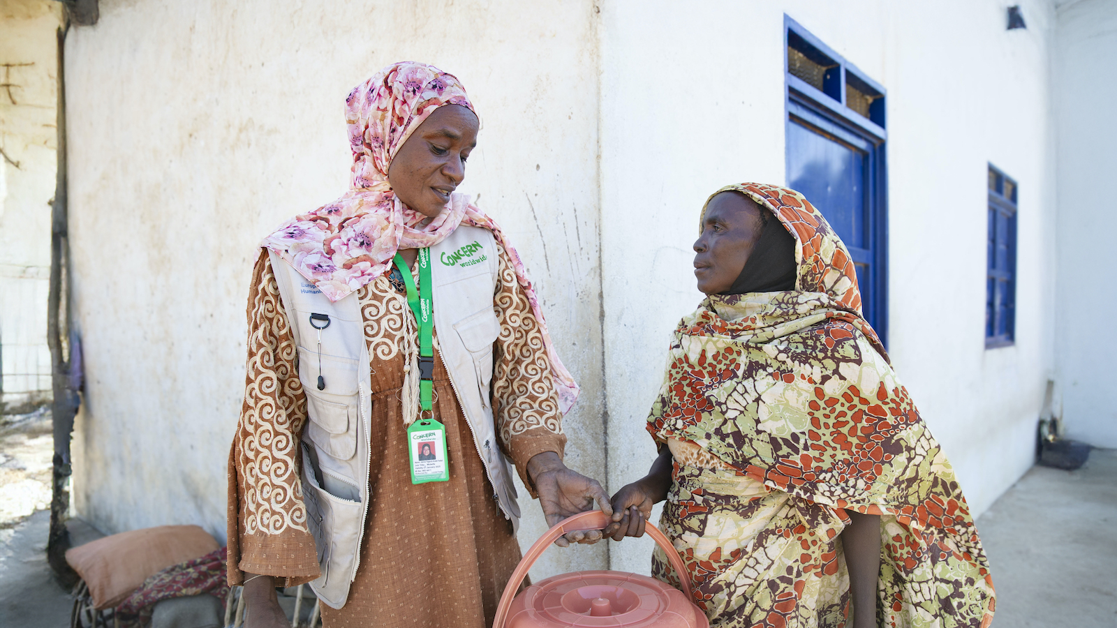Concern team member Yanna Yagoub Arabi Fadul with Nadima* at a distribution of hygiene kits at Ban Jadid, West Darfur, Sudan, targeting vulnerable households in 10 of the surrounding villages. Photo: Kieran McConville/Concern Worldwide