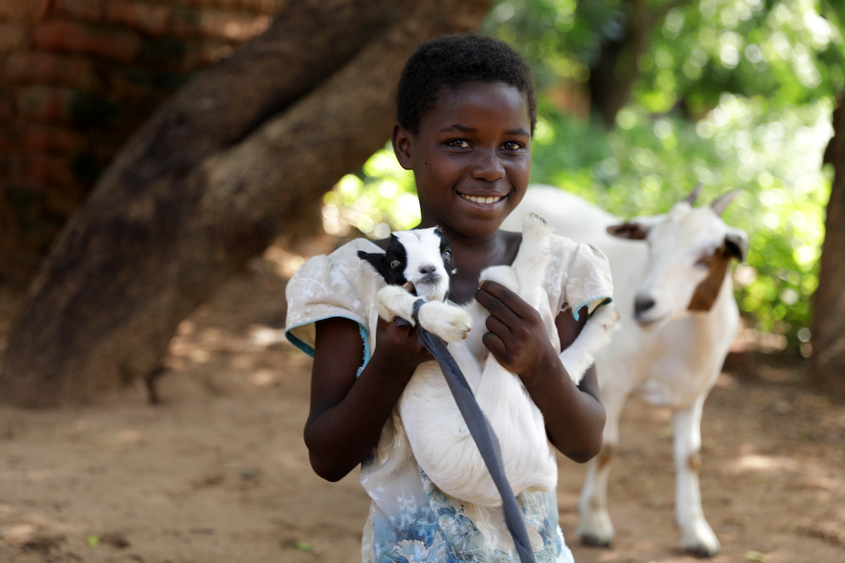 Nine-year-old Omega with her goat in Nsanje, Malawi