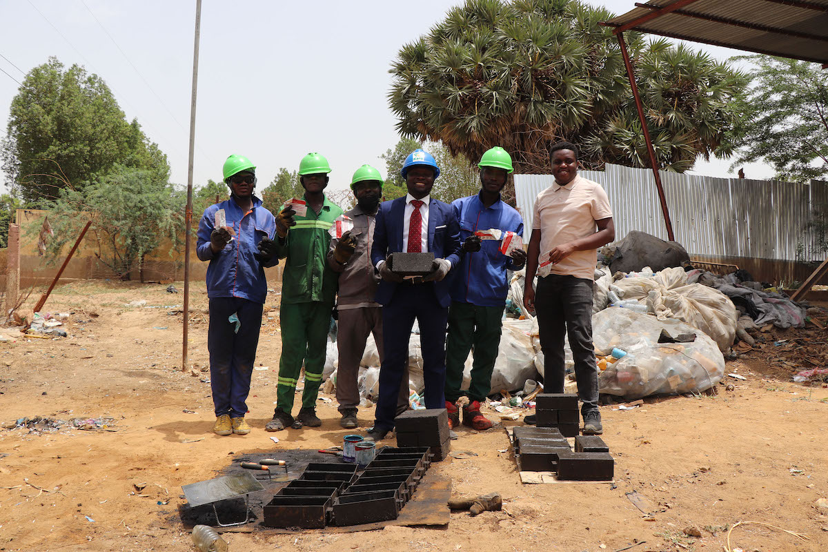 Karö CEO Bindah Dingaotabet Ghislain (center), with several team members. The organization collected over 12,800 empty RUTF packages from Concern Chad and upcycled them into 600 bricks and paving stones. (Photo: Pierre Maget/Concern Worldwide)