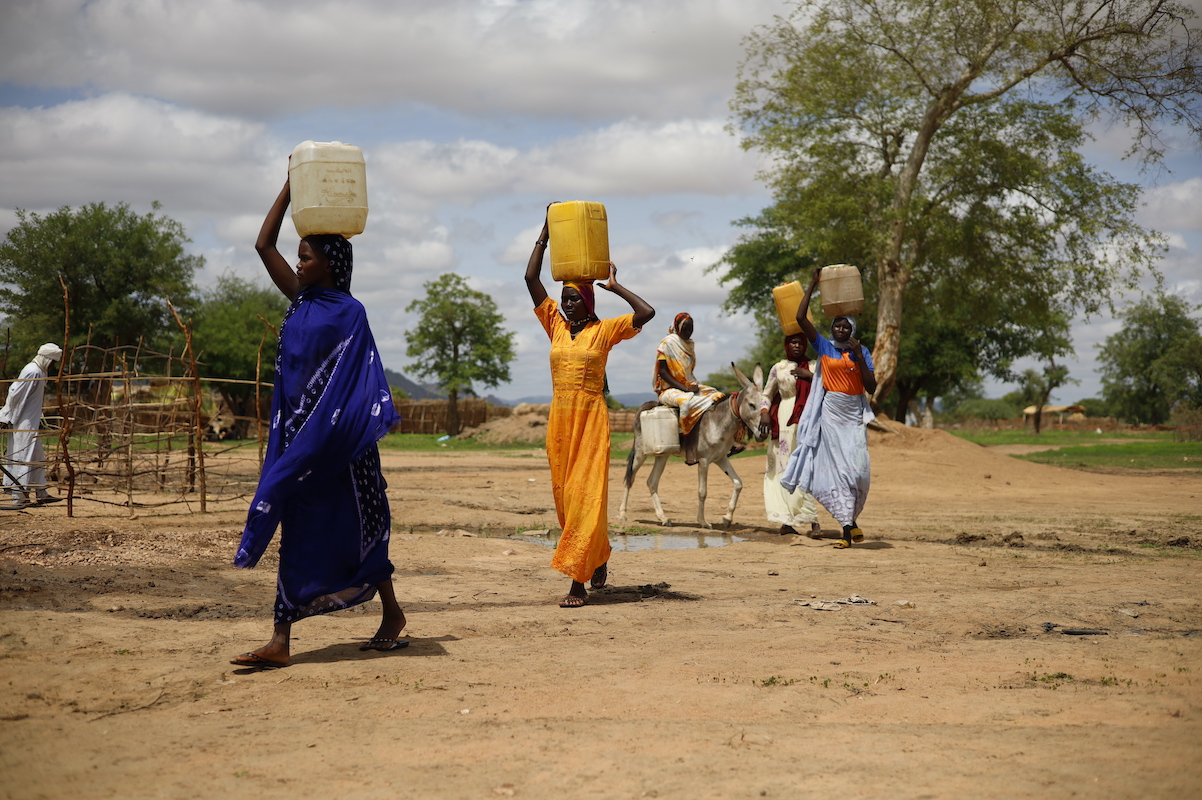 Women collecting water at new water point that Concern built near Dog Dore, Sila Province