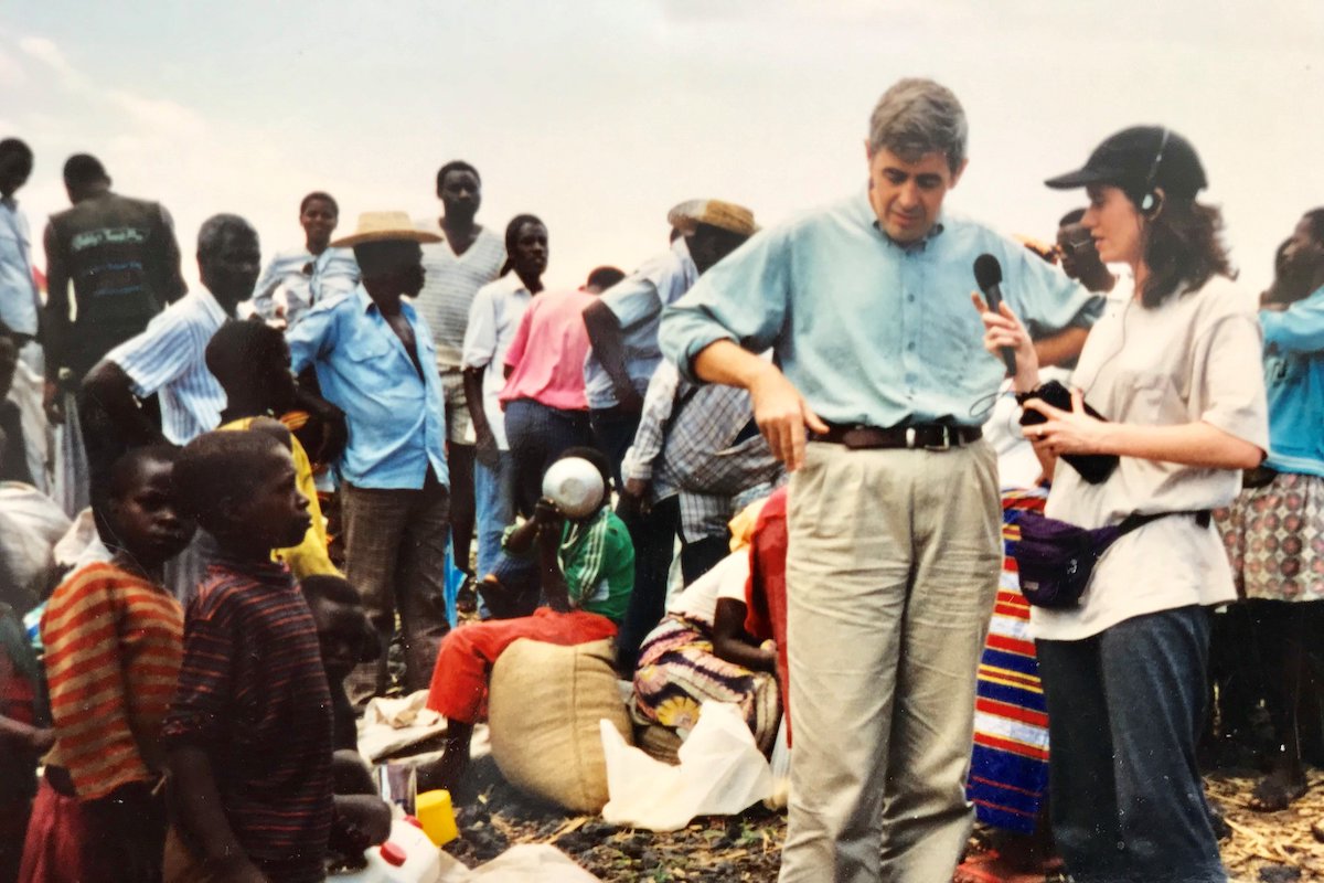 Concern volunteer Noel Molony escorts a cholera patient to a health center in Rwanda, 1994.