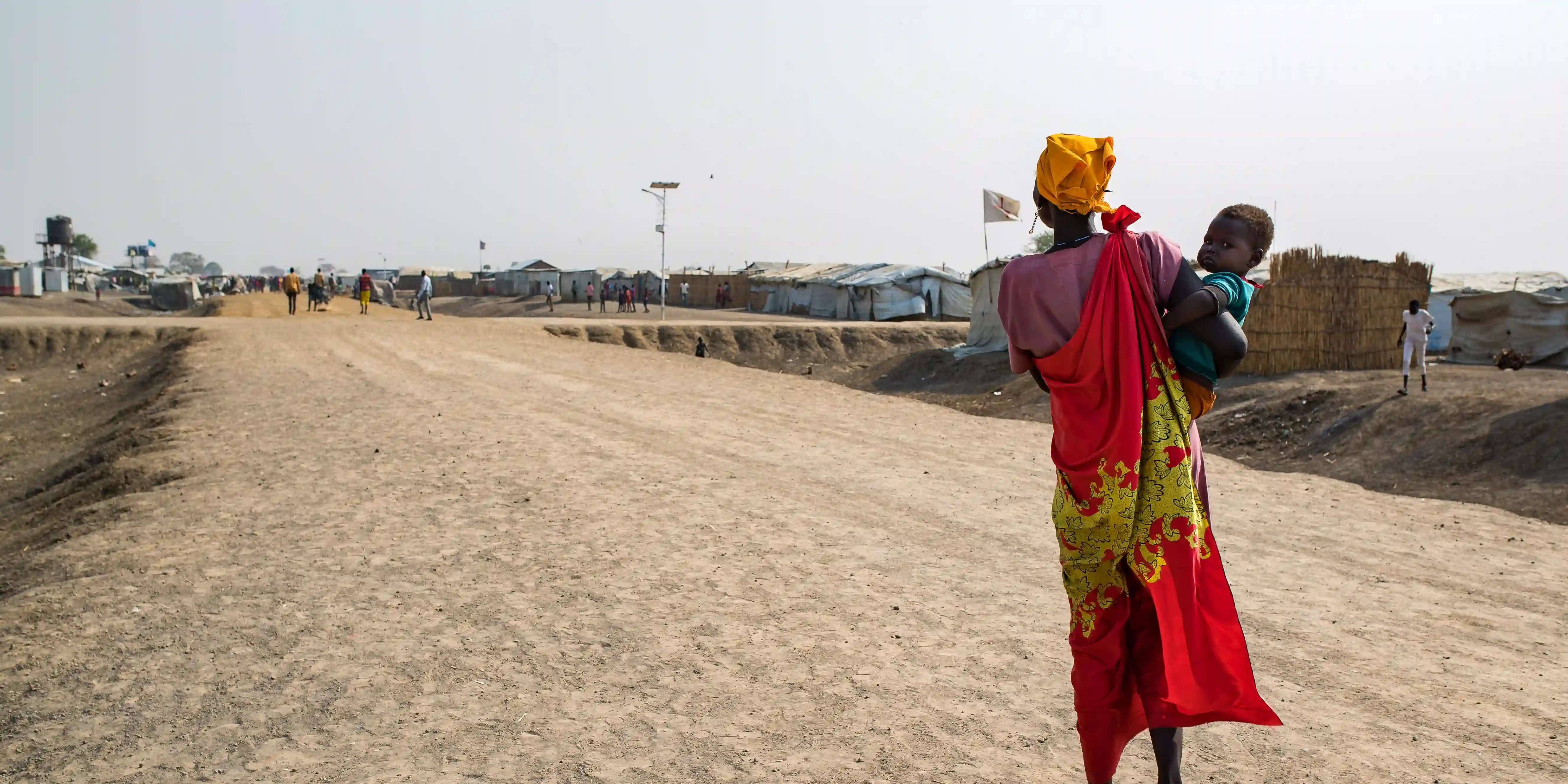 Anna George (39) walks home with her little boy Chieng Jal (3)