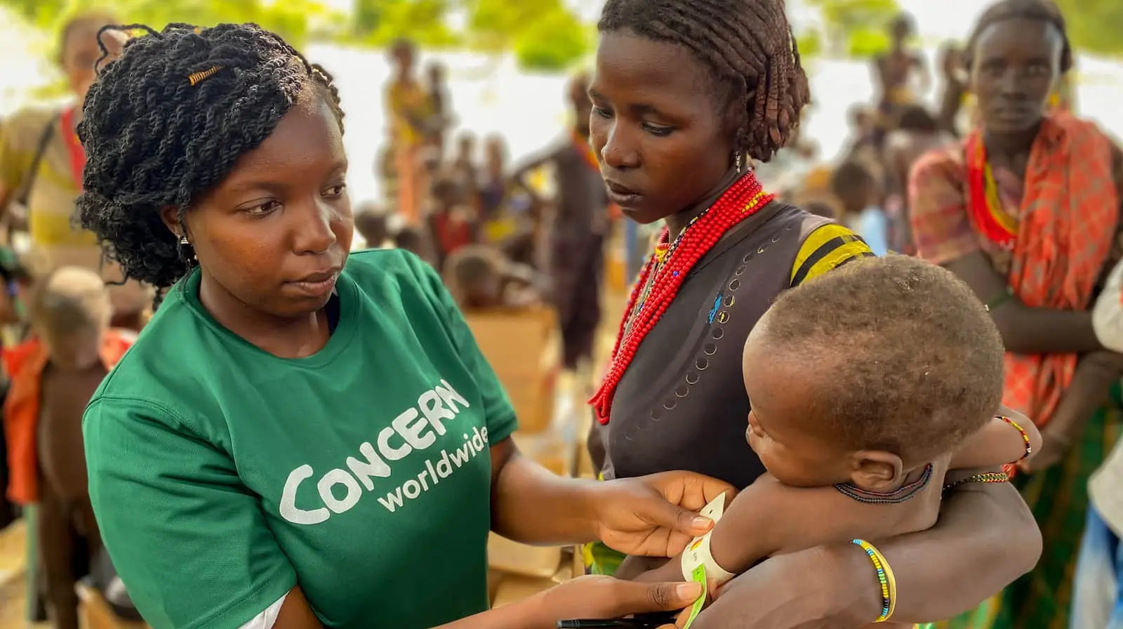 Concern worker with a mother and child