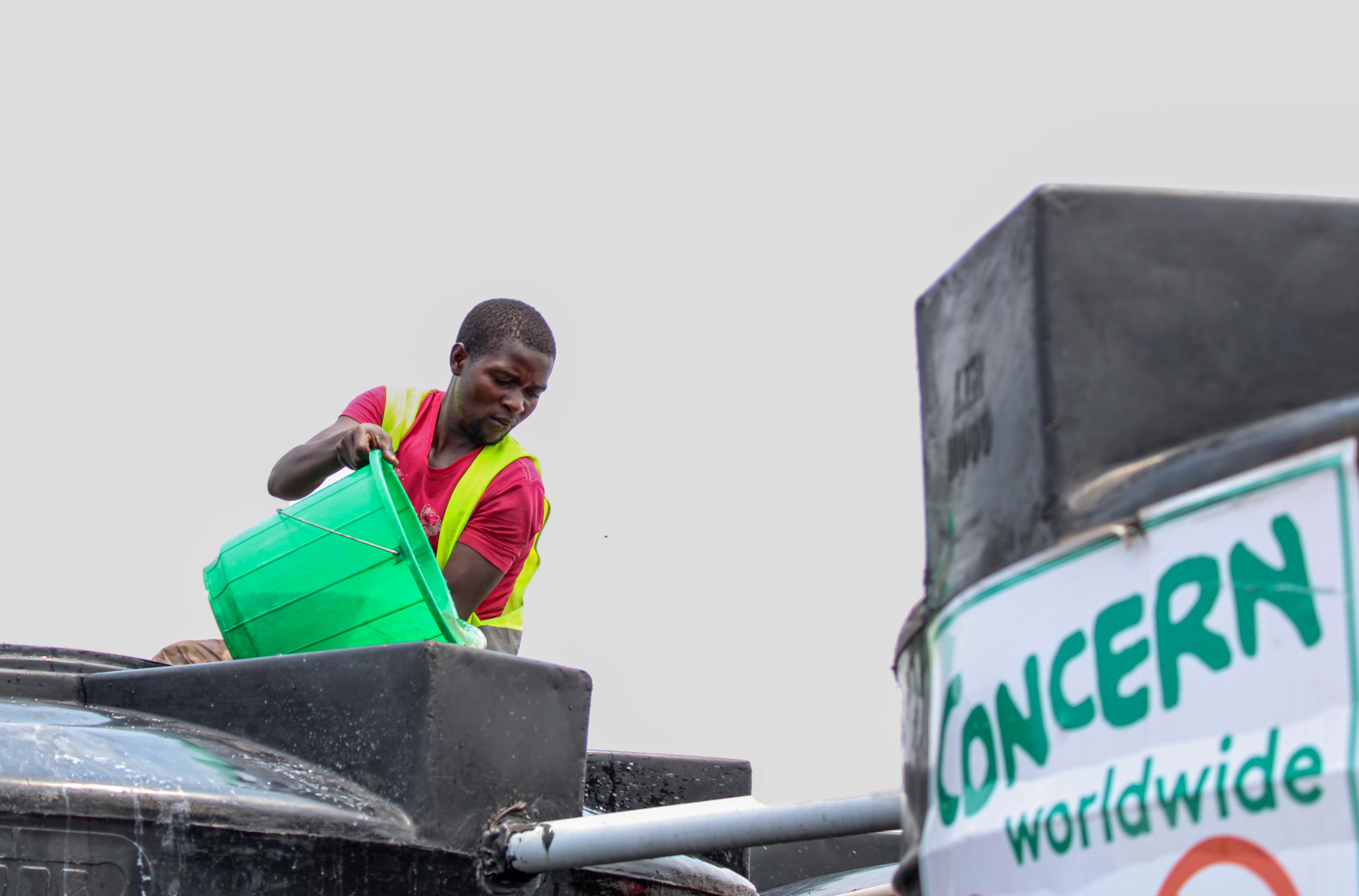 Concern workers empties water tank