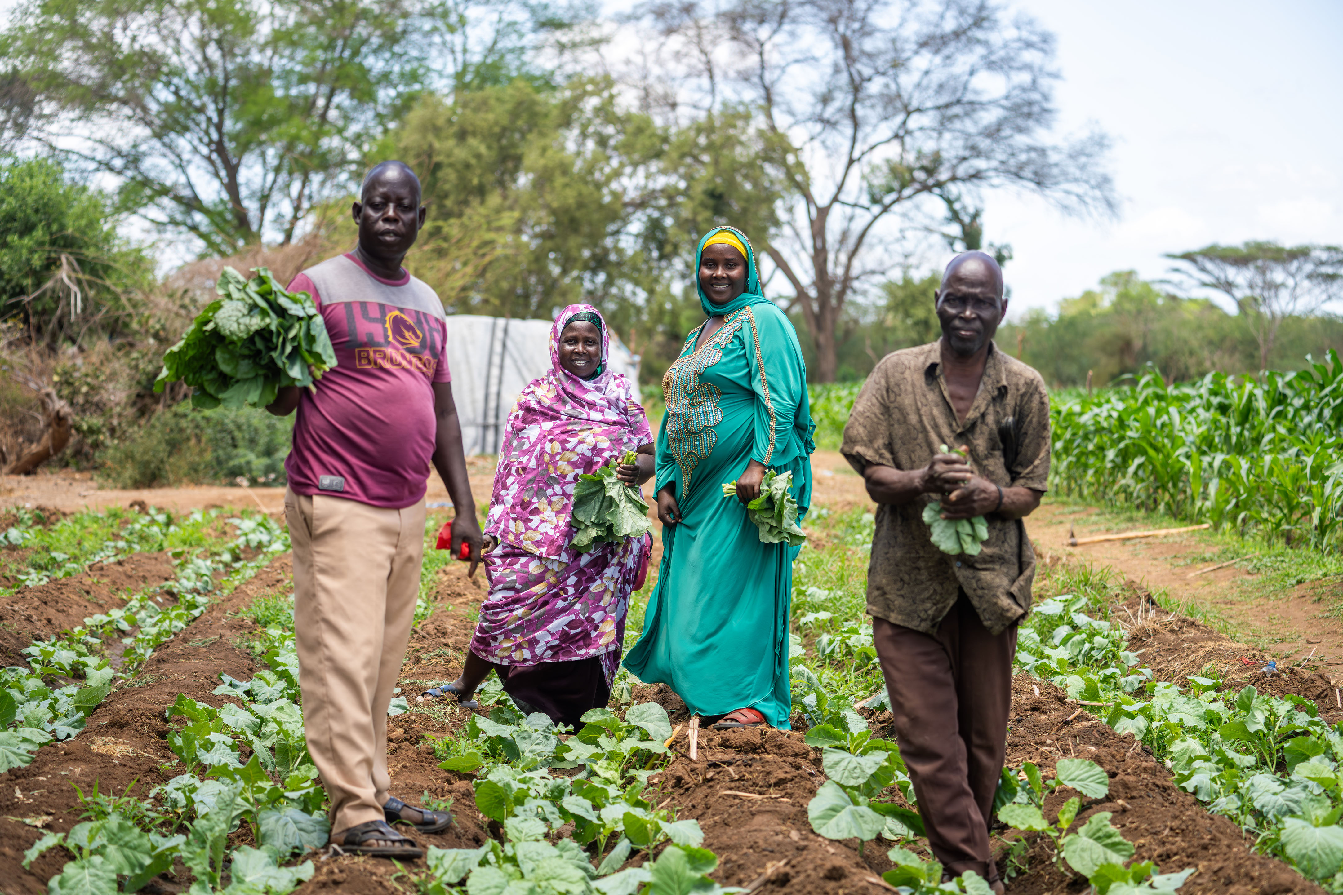 Group of Farmers Holding Crops