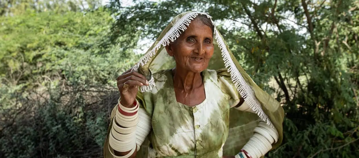 Elderly woman posing with garment over her head