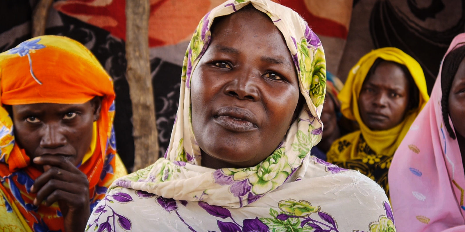 Woman in colorful headscarf looking to camera