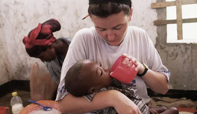 Irish nurse, Valerie Place, feeds a starving child during the Somalia famine in 1993. Soon after this photo was taken, Valerie was killed in an ambush outside Mogadishu.